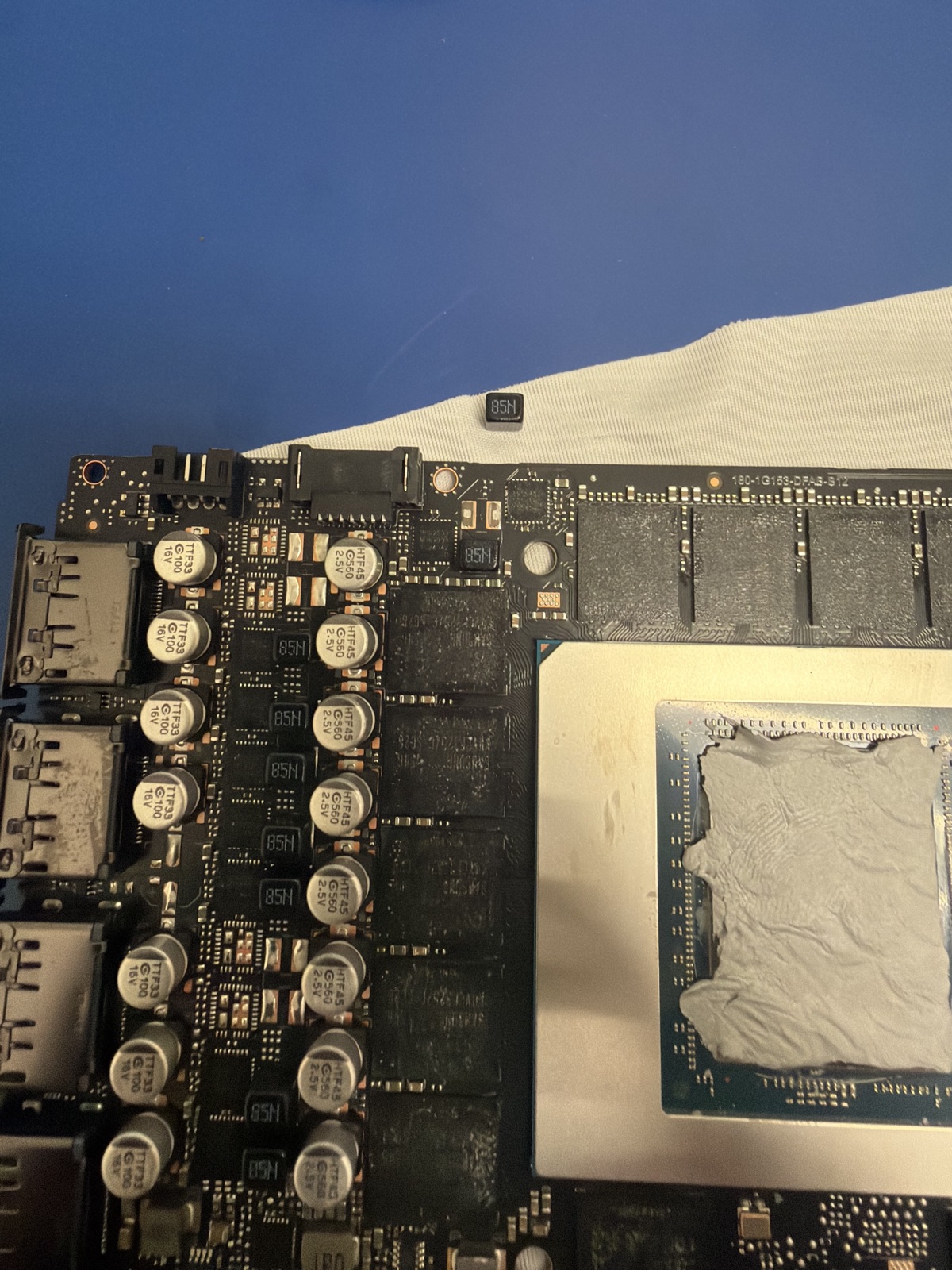 The card I damaged during a block install — a popped capacitor on the PCB beside the die, later brought back to life by ZapFixers