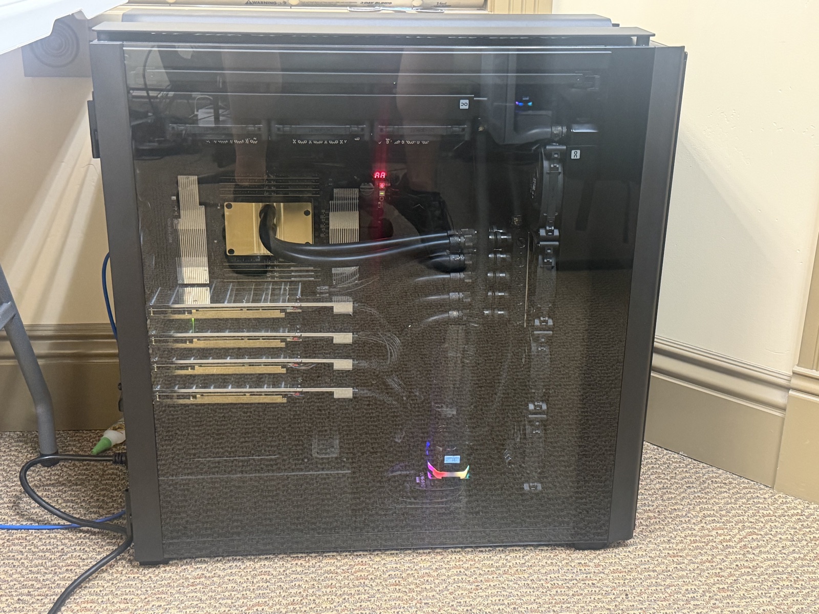 First boot — glass on, four cards, the AA debug LED counting up in the corner